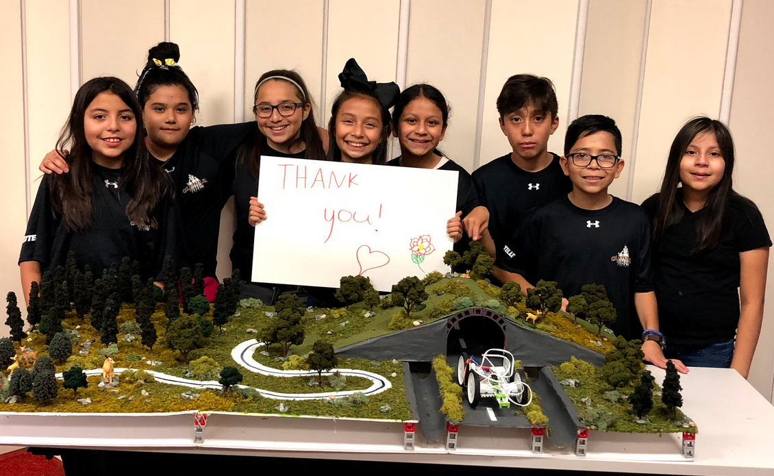 SpringSpirit youth with their winning STEM Competition entry prototype of an ecosystem with a highway running through it.